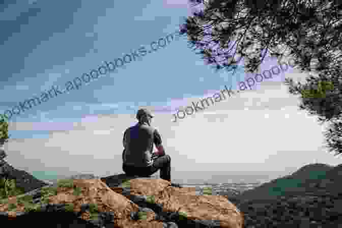 A Hiker Sits On A Rock, Looking Out At A Stunning Sunset. Vintage Treks Dr Lew Deitch