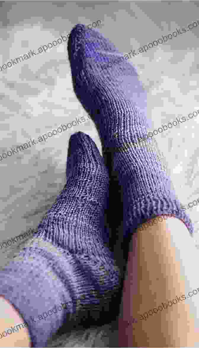 A Person Wearing A Pair Of Pattern Bed Socks While Reading A Book In A Cozy Armchair, Surrounded By Warm And Inviting Decor. Plymouth F073 Baby Alpaca DK Yarn Pattern Bed Socks (I Want To Knit)